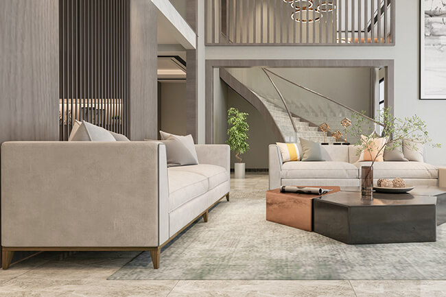 Royal Apex Interior Works Portfolio - Modern Living Room Interior A modern living room interior with a stylish sofa, coffee table, and rug. The walls are painted a light gray color, and the ceiling is high and airy. The windows are large and let in plenty of natural light. The overall space is comfortable and inviting.